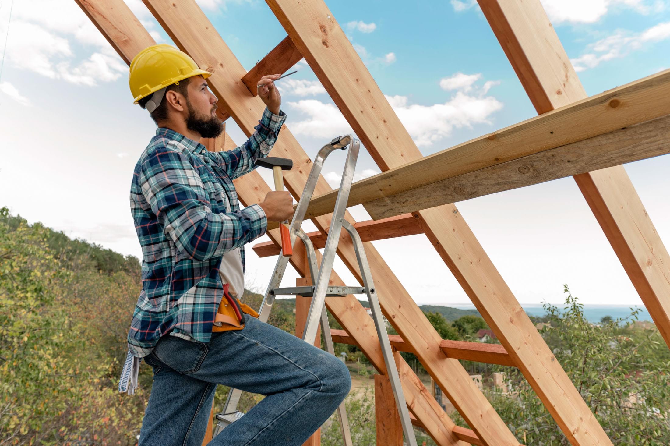 construction worker with hard hat hammer building roof house